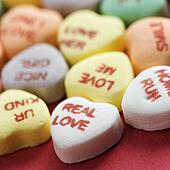 Picture of Colorful candy hearts with sayings on them arranged to spell